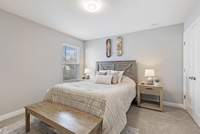 bedroom featuring light colored carpet and baseboards