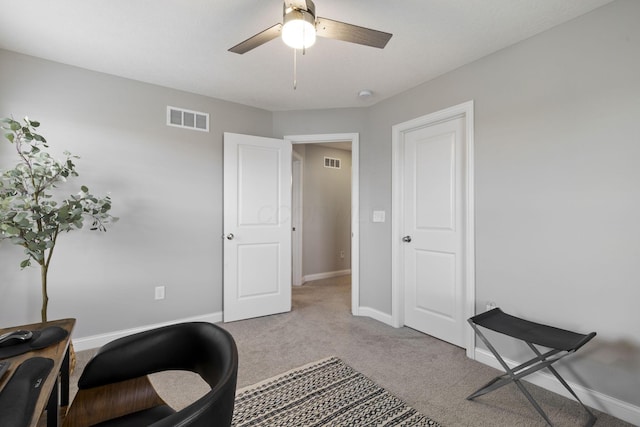 carpeted home office with visible vents, ceiling fan, and baseboards