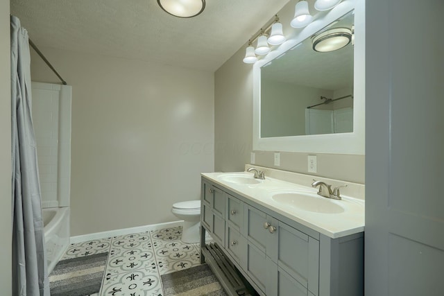 full bathroom with toilet, shower / bath combo, a sink, and baseboards