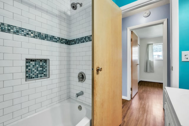 full bathroom with  shower combination, vanity, baseboards, and wood finished floors