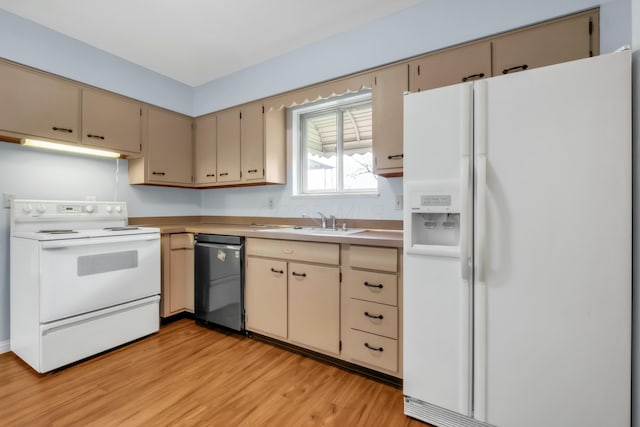 kitchen with white appliances, light wood-style flooring, a sink, and cream cabinetry