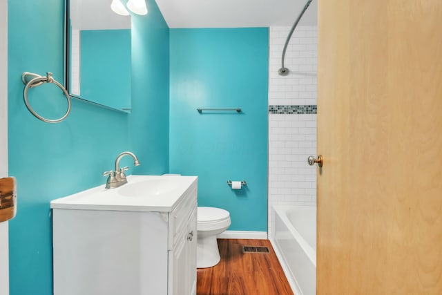 full bath with vanity, toilet, visible vents, tub / shower combination, and wood finished floors