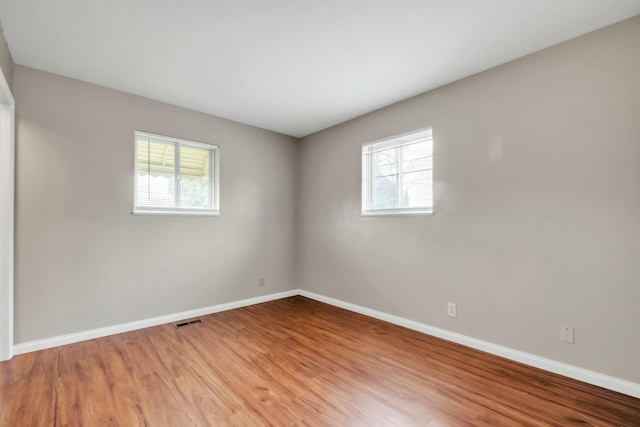 empty room with visible vents, baseboards, and a healthy amount of sunlight