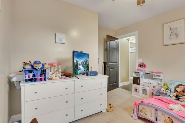 bedroom with ceiling fan, light colored carpet, and baseboards