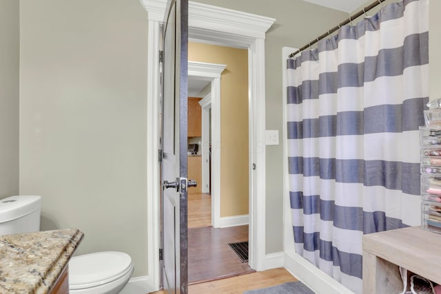 full bathroom with visible vents, toilet, wood finished floors, and baseboards