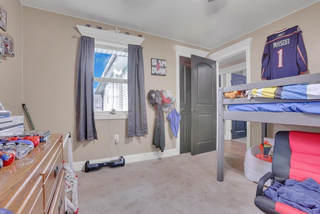 bedroom featuring carpet and baseboards