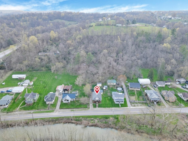 bird's eye view with a wooded view and a residential view
