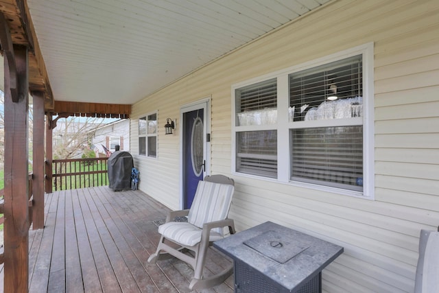 wooden terrace featuring grilling area and a porch