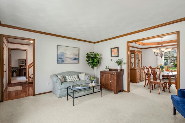 living area featuring baseboards, carpet floors, a notable chandelier, and ornamental molding