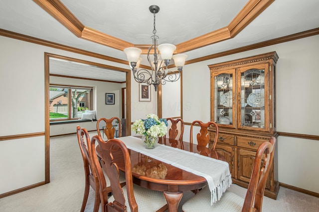 dining space with a notable chandelier, crown molding, and light carpet