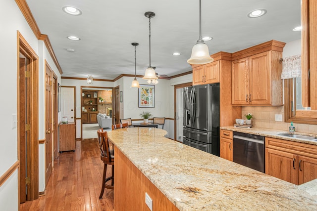 kitchen featuring backsplash, crown molding, stainless steel appliances, and recessed lighting