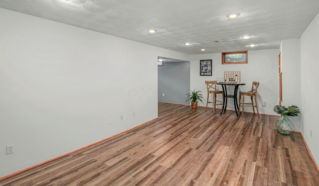 finished basement featuring baseboards, wood finished floors, and recessed lighting