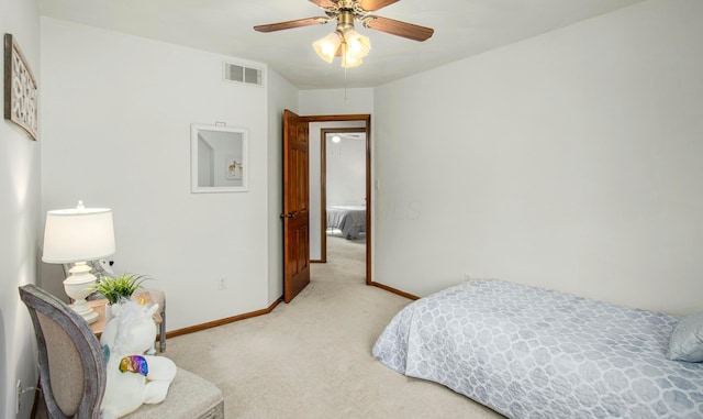 bedroom with baseboards, visible vents, light colored carpet, and ceiling fan