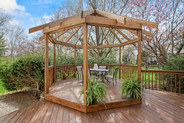 deck featuring a gazebo and outdoor dining space