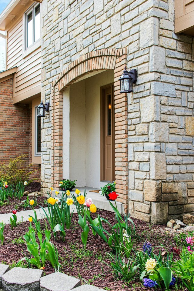 property entrance with stone siding