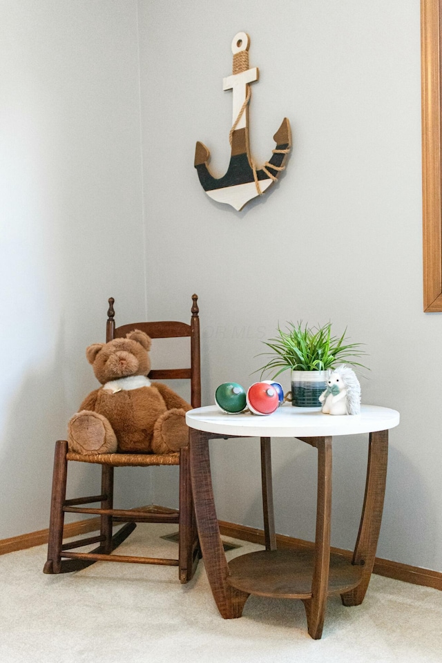 carpeted dining room with baseboards
