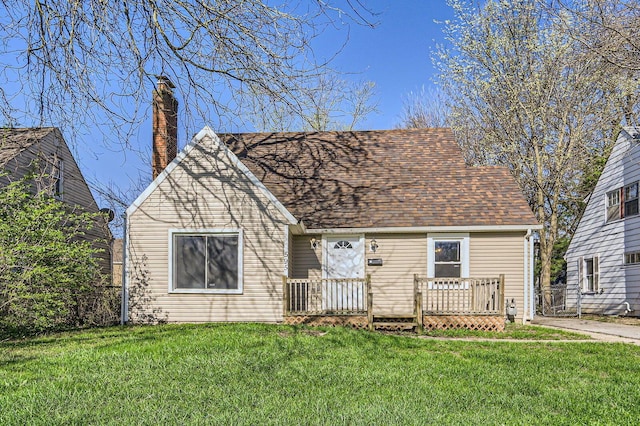 595 Collingwood Ave, Columbus, OH 43213 - view of front of home with a chimney, a front lawn, a wooden deck, and a shingled roof