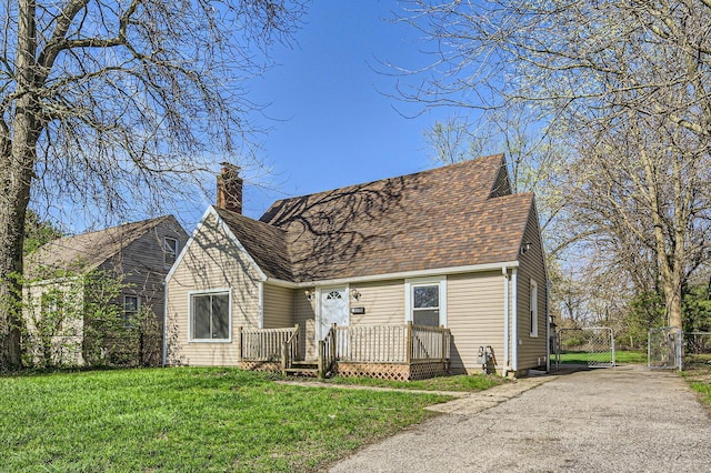 595 Collingwood Ave, Columbus, OH 43213 - view of front facade with a shingled roof, a chimney, a gate, and a front yard