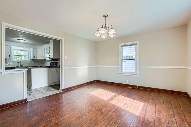 595 Collingwood Ave, Columbus, OH 43213 - interior space featuring a chandelier, light wood-type flooring, and baseboards