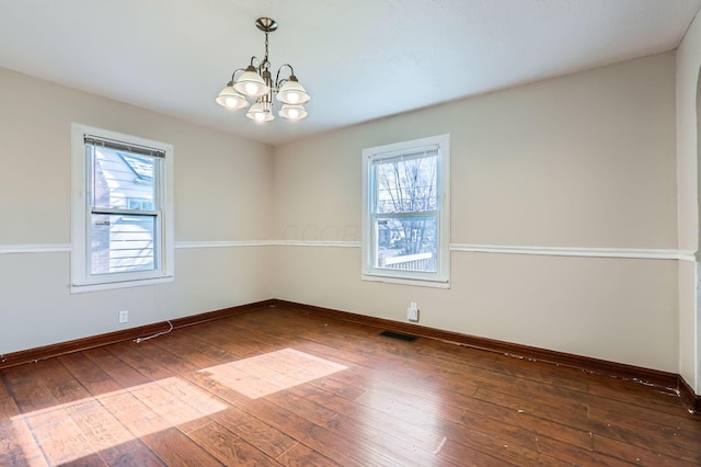 595 Collingwood Ave, Columbus, OH 43213 - unfurnished room with plenty of natural light, baseboards, visible vents, and an inviting chandelier