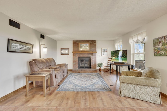 1649 Loudon St, Granville, OH 43023 - living area with a brick fireplace, light wood-style flooring, and visible vents