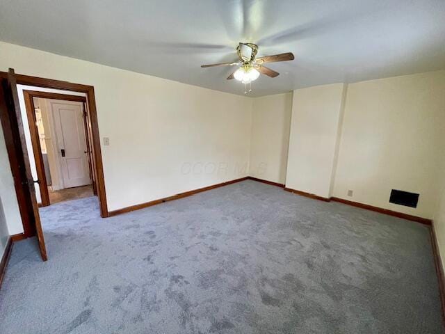 empty room featuring a ceiling fan, carpet flooring, and baseboards