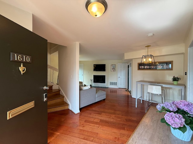 1610 Lafayette Dr Unit 1610, Columbus, OH 43220 - living area with wood finished floors, a chandelier, stairway, and a fireplace
