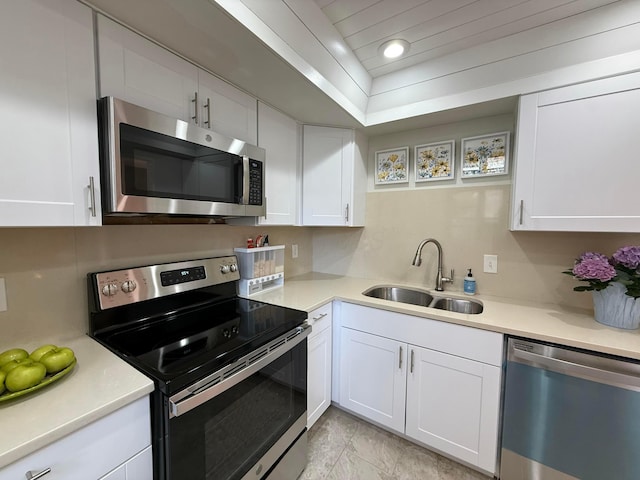 1610 Lafayette Dr Unit 1610, Columbus, OH 43220 - kitchen with stainless steel appliances, a sink, white cabinets, and recessed lighting