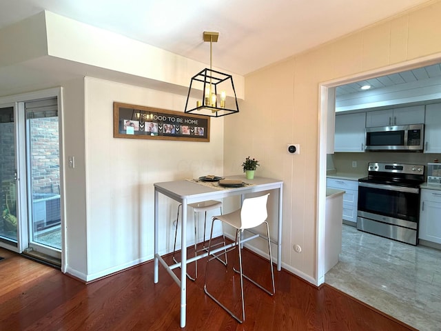 1610 Lafayette Dr Unit 1610, Columbus, OH 43220 - dining room with wood finished floors, baseboards, and a chandelier