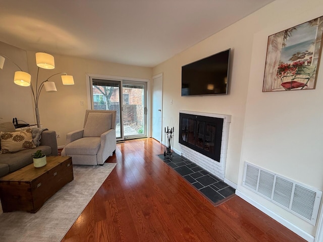1610 Lafayette Dr Unit 1610, Columbus, OH 43220 - living area featuring dark wood finished floors, a tiled fireplace, and baseboards