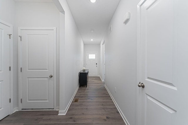 corridor with recessed lighting, dark wood-type flooring, and baseboards