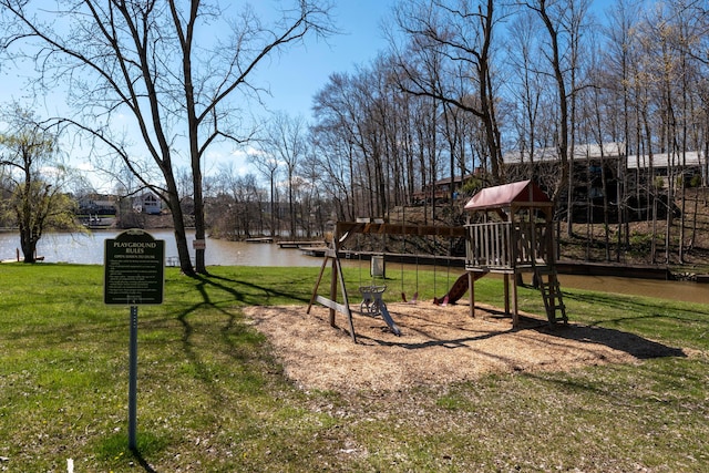 view of yard with playground community and a water view