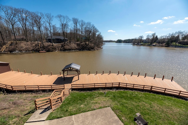 dock area with fence and a water view