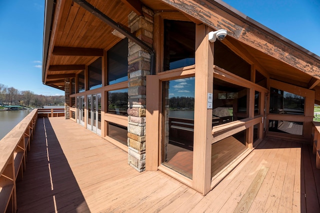 wooden terrace featuring a water view