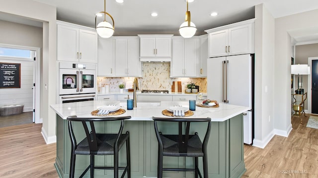 kitchen featuring light wood-style flooring, baseboards, and white cabinetry