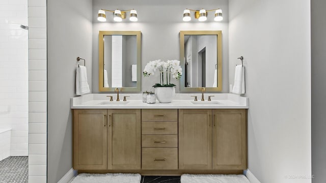 bathroom featuring a sink, double vanity, and tiled shower