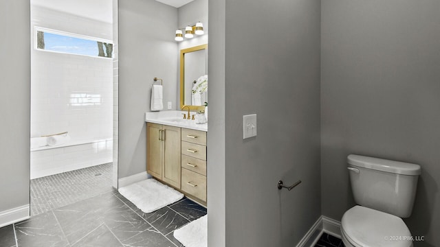 bathroom with vanity, marble finish floor, baseboards, toilet, and a walk in shower