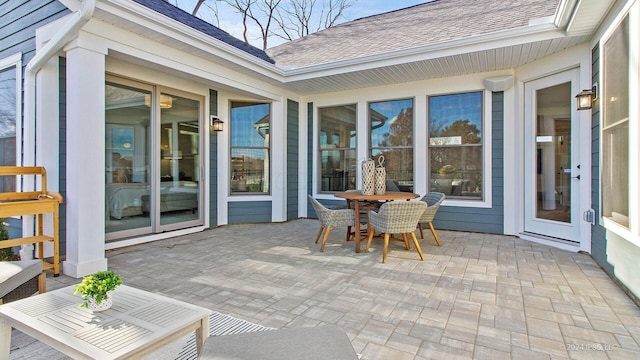 sunroom featuring outdoor dining area