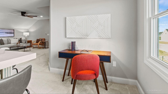 office area featuring carpet flooring, a wealth of natural light, vaulted ceiling, baseboards, and ceiling fan