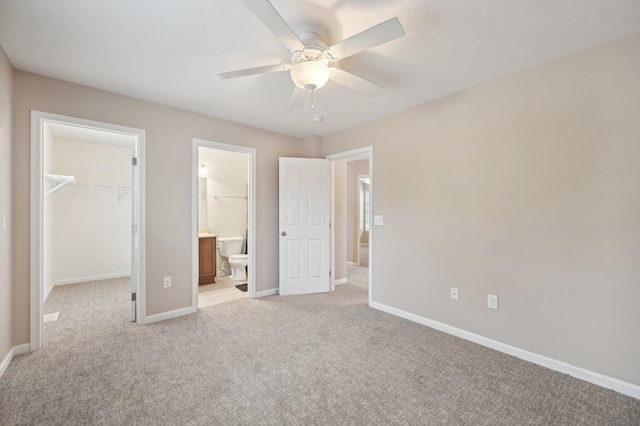 3947 Summerstone Dr, Columbus, OH 43230 - unfurnished bedroom with a walk in closet, light carpet, a closet, and baseboards