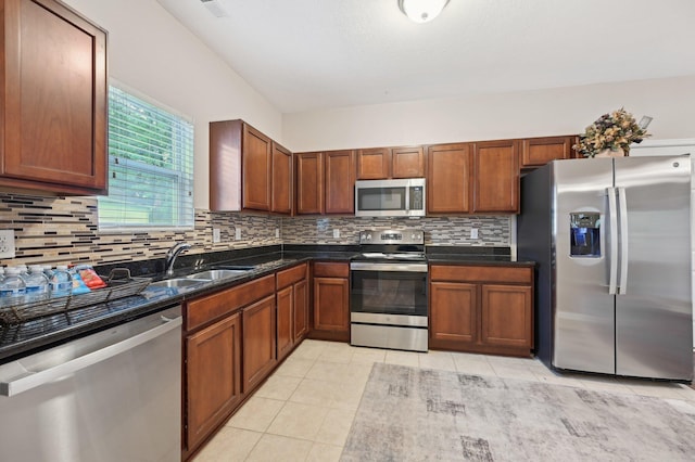 3947 Summerstone Dr, Columbus, OH 43230 - kitchen with stainless steel appliances, a sink, light tile patterned floors, tasteful backsplash, and brown cabinets