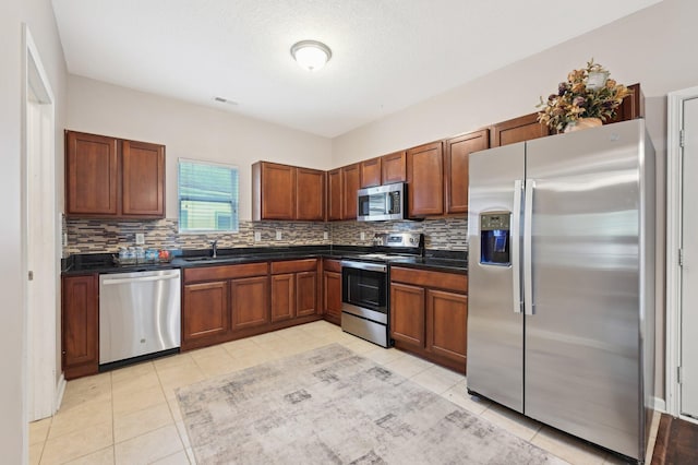 3947 Summerstone Dr, Columbus, OH 43230 - kitchen featuring stainless steel appliances, dark countertops, decorative backsplash, and a sink