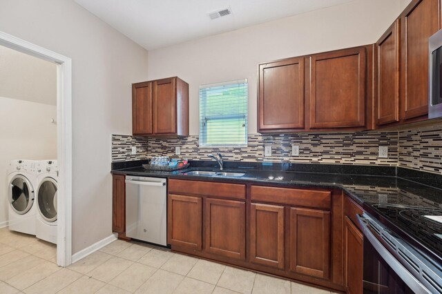 3947 Summerstone Dr, Columbus, OH 43230 - kitchen featuring appliances with stainless steel finishes, washing machine and dryer, a sink, tasteful backsplash, and light tile patterned floors