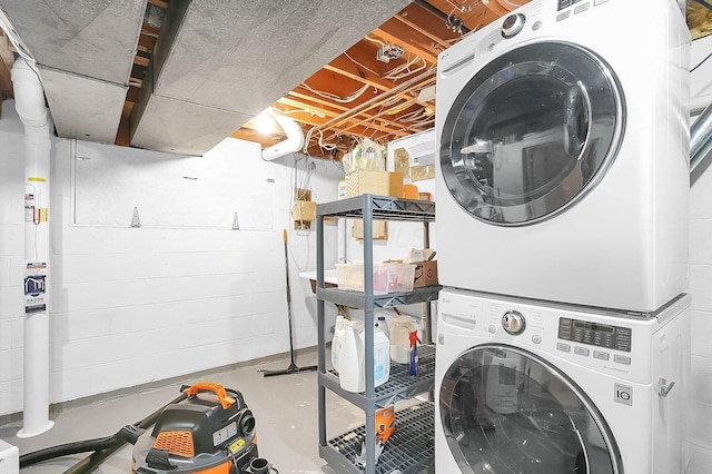laundry area featuring stacked washing maching and dryer and laundry area