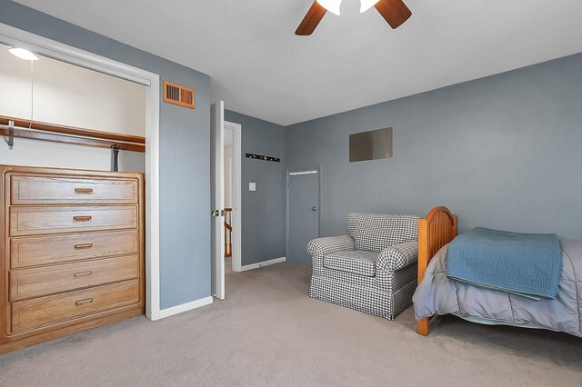 carpeted bedroom featuring visible vents, baseboards, and ceiling fan