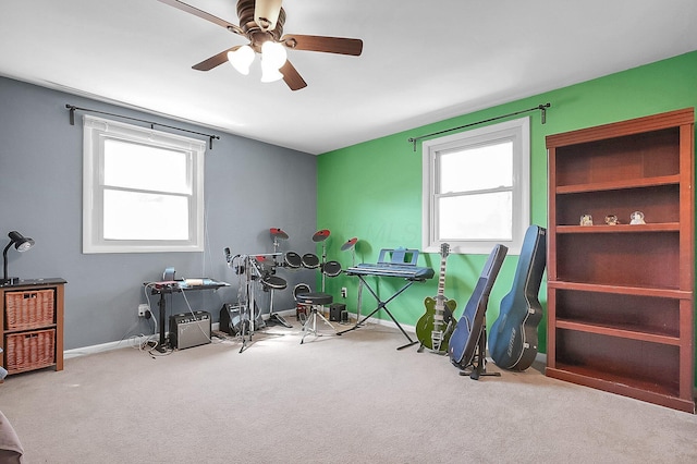recreation room with carpet floors, baseboards, and a ceiling fan