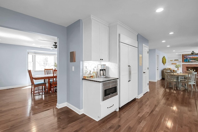 bar featuring built in appliances, baseboards, recessed lighting, a ceiling fan, and dark wood finished floors