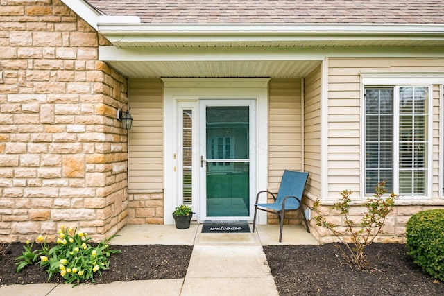 4889 Ashleigh Dr, Dublin, OH 43016 - view of exterior entry featuring roof with shingles and stone siding