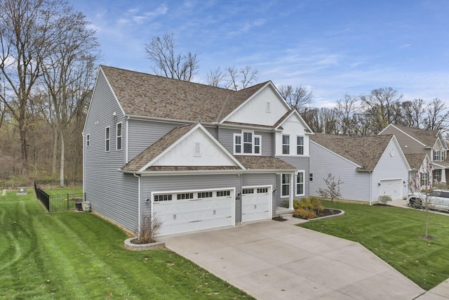 traditional-style house with a front yard, an attached garage, fence, driveway, and roof with shingles