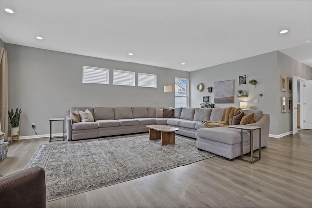living room featuring wood finished floors, baseboards, and recessed lighting